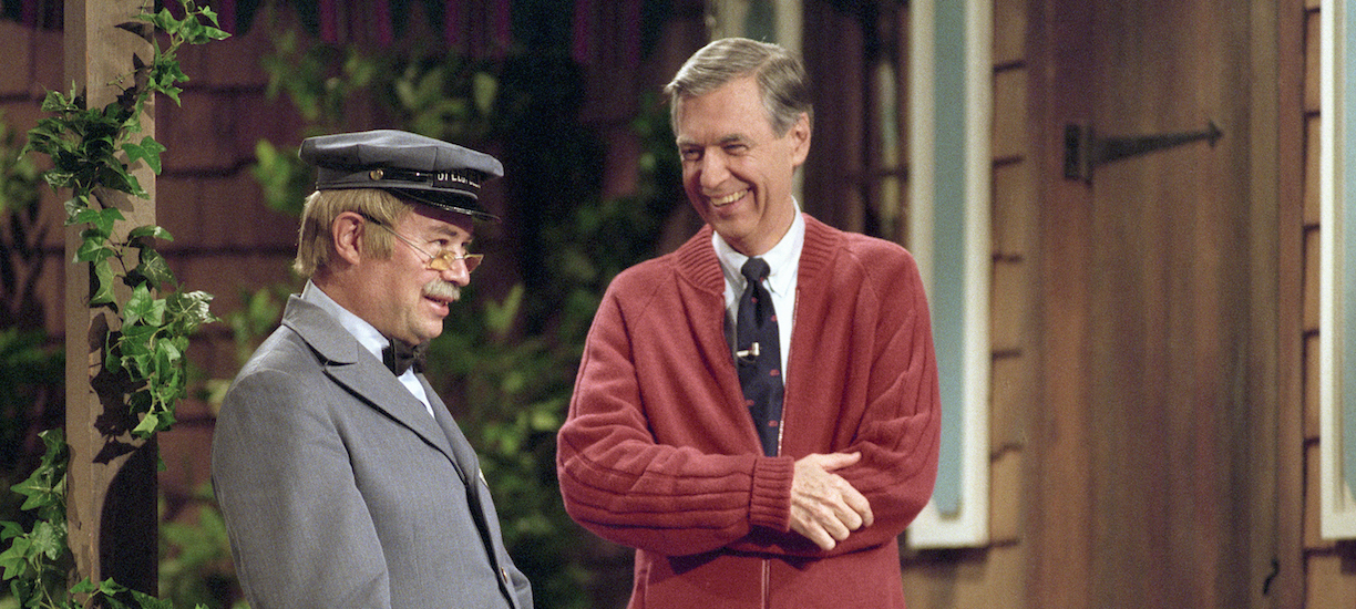 Fred Rogers and David Newell in costume on porch set of Mister R